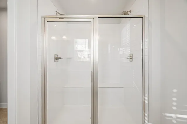 a bathroom with a glass shower door