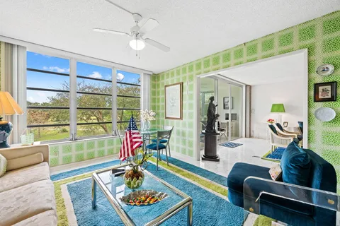 a living room with furniture and a floor to ceiling window