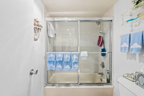 a bathroom with a shower and a bath tub