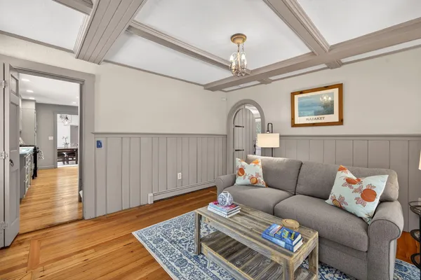 a living room with furniture a rug and a chandelier