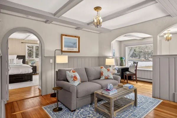 a bedroom with a large bed and a chandelier