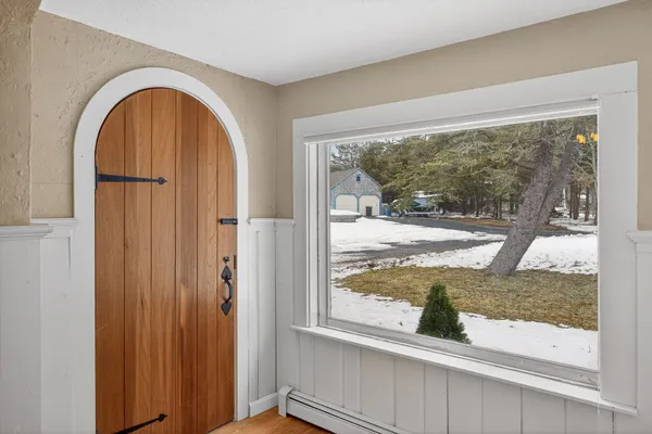a bathroom with a sink mirror and a window