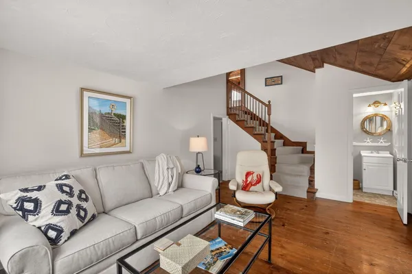 a dining room with furniture water view and wooden floor