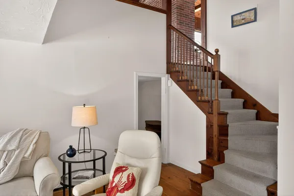 a living room with furniture large windows and a fireplace