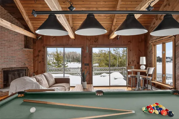 an aerial view of a house with a yard and lake view