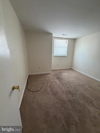 an empty room with closet area and mirror