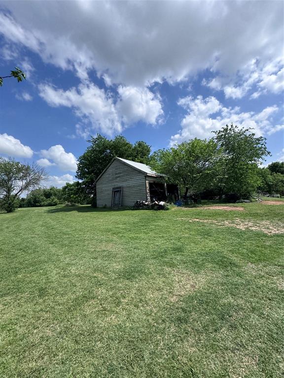 806 Old Base Road Aurora, TX 76078 - Photo 7 of 23 a front view of a house with a yard and tree