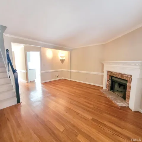 wooden floor in an empty room with a fireplace