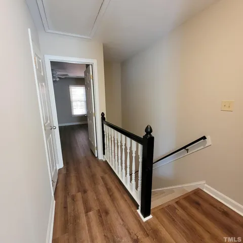 a view of a hallway view with wooden floor and staircase