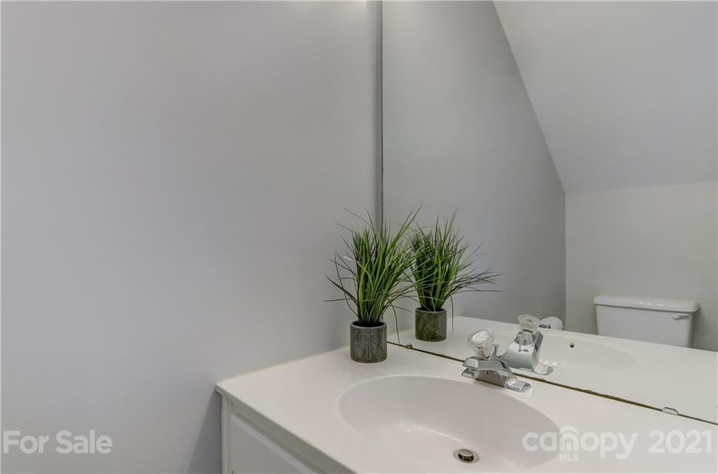 10208 Roundleaf Drive Charlotte, NC 28213 - Photo 12 of 26 a bathroom with a sink a mirror and next to a window