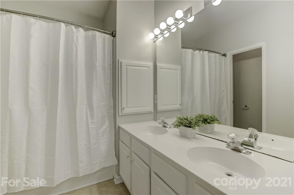 10208 Roundleaf Drive Charlotte, NC 28213 - Photo 15 of 26 a bathroom with a double vanity sink and a mirror