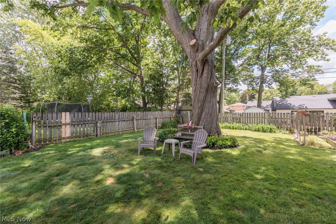 5364 Summit Road Lyndhurst, OH 44124 - Photo 24 of 42 Expansive backyard featuring a mature central tree, manicured lawn, and perimeter wood fencing