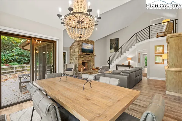 a kitchen with a table chairs and wooden floor