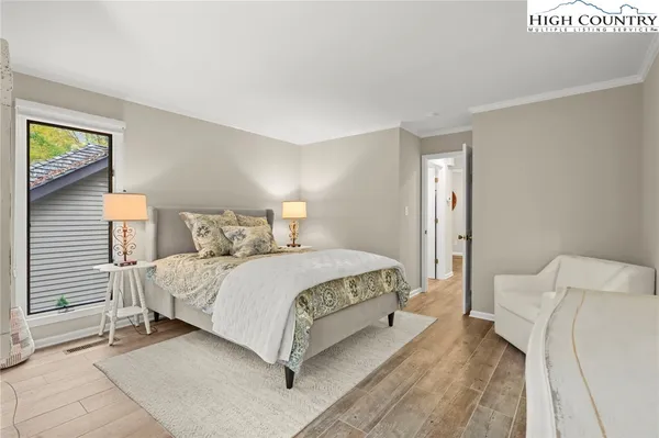 a bedroom with a bed and a night stand