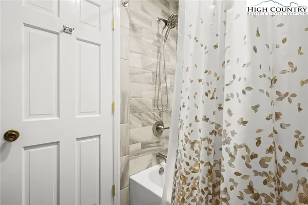 a bathroom with a shower curtain