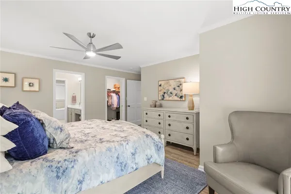 a bedroom with a bed a couch and dresser