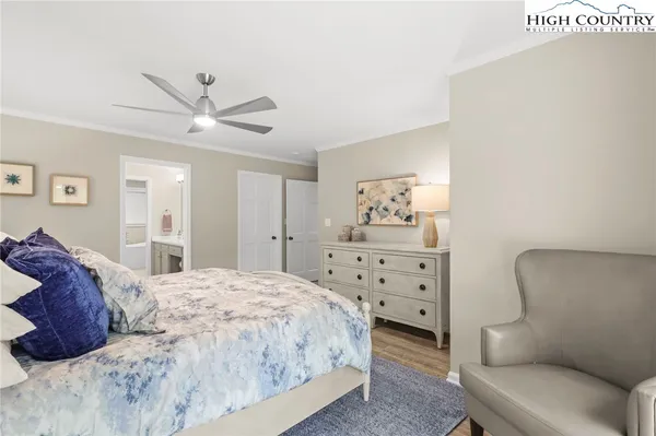 a bedroom with a bed window and couch