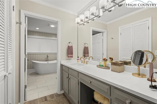 a bathroom with a double vanity sink mirror and bathtub