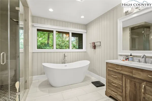 a spacious bathroom with a bathtub and sink