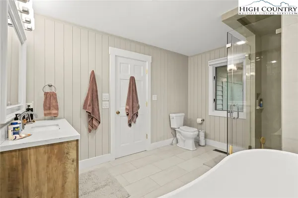 a bedroom with a bed and a large mirror