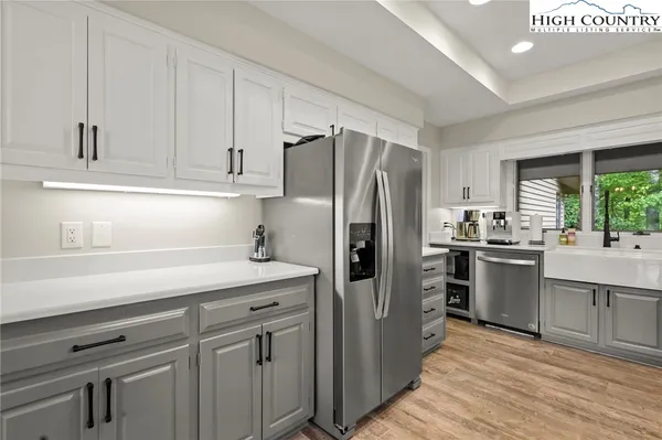 a kitchen with a sink stainless steel appliances and window