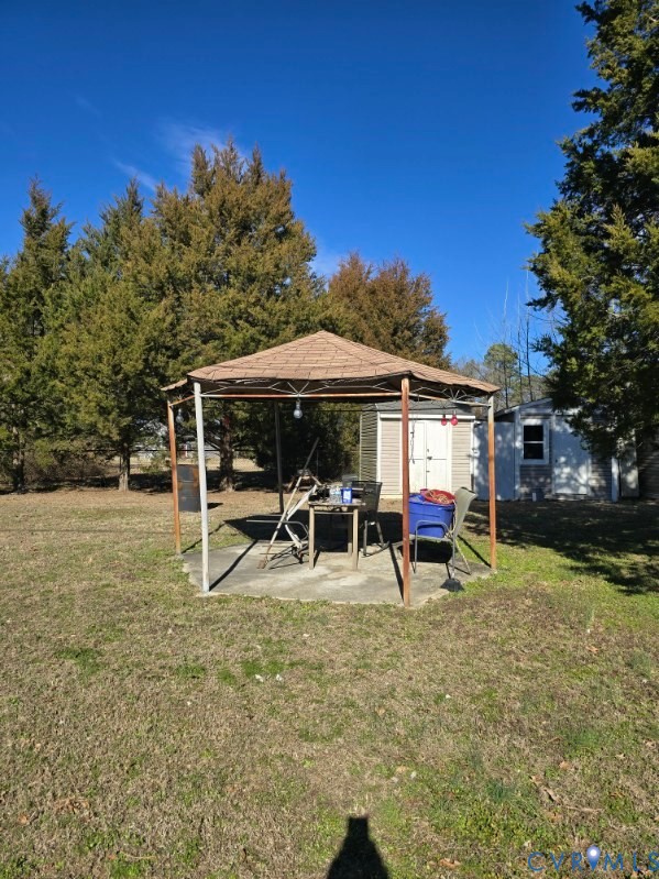 16023 Flatfoot Road Dinwiddie, VA 23841 - Photo 4 of 9 a view of a house with backyard porch and sitting area