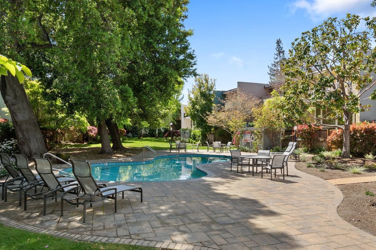 171 Forest Lane Menlo Park, CA 94025 - Photo 14 of 16 a view of a patio with table and chairs potted plants and a large tree