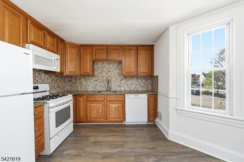 104 Maple Avenue, Unit 2 Morristown, NJ 07960 - Photo 18 of 23 a kitchen with stainless steel appliances granite countertop a stove a sink and a microwave