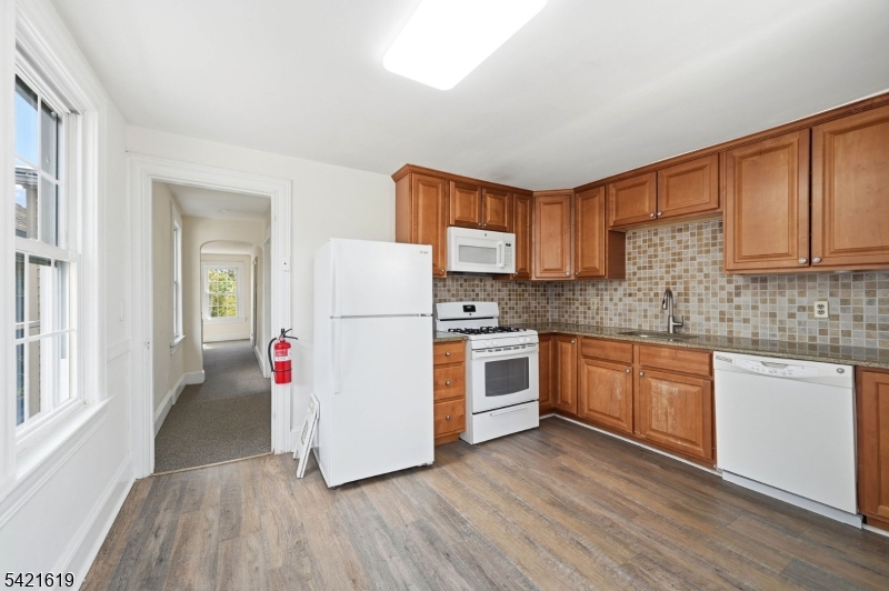 104 Maple Avenue, Unit 2 Morristown, NJ 07960 - Photo 19 of 23 a kitchen with granite countertop white cabinets and white appliances