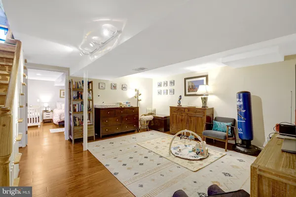 a bedroom with furniture and a wooden floor