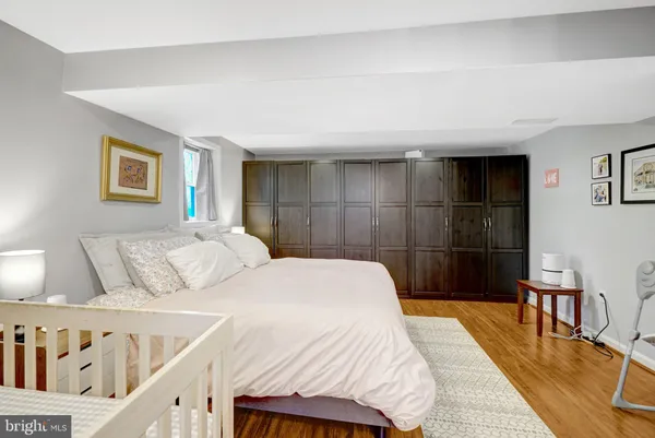 a bedroom with a bed and a potted plant