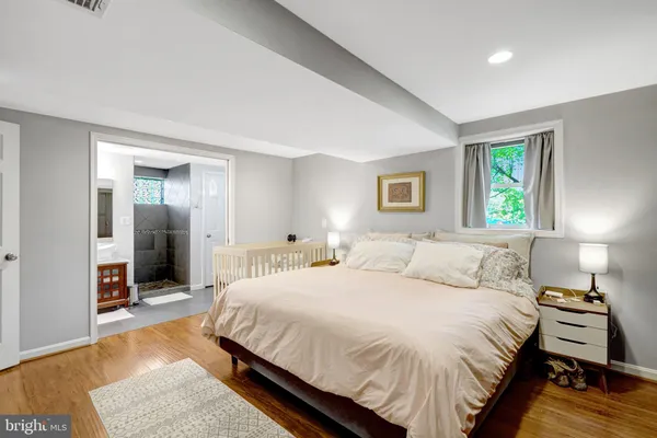 a bedroom with bed and a night stand