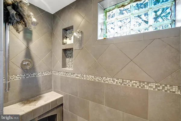 a bathroom with a bathtub and shower