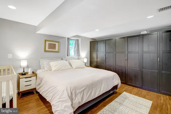 a bedroom with a bed and a night stand