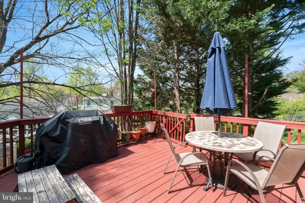 a view of a patio with table and chairs and wooden floor