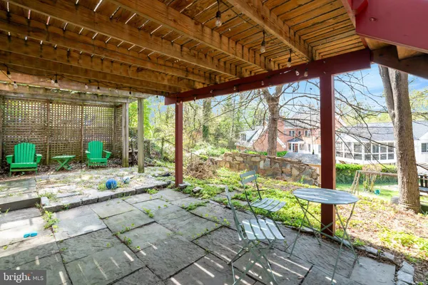 a building outdoor space with patio furniture and potted plants