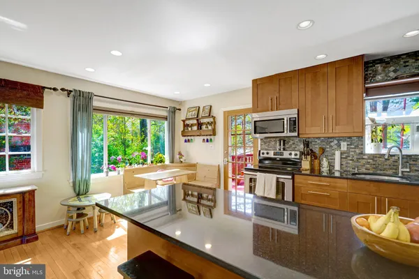 a kitchen with stainless steel appliances granite countertop sink stove top oven and cabinets