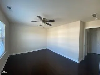 a view of a room with wooden floor and a window