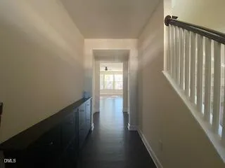 a view of a hallway with wooden floor
