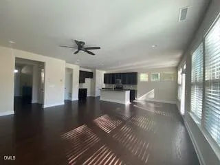 a view of livingroom with hardwood floor and a ceiling fan