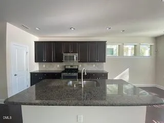 a kitchen with sink cabinets and window