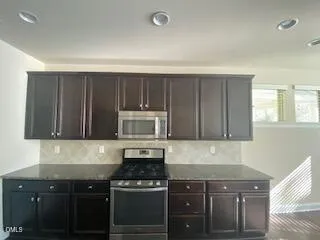 a kitchen with a stove and a microwave