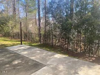 a view of a field with trees in the background