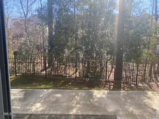 a view of a yard with a wooden fence