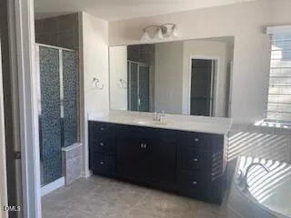 a bathroom with a double vanity sink and mirror