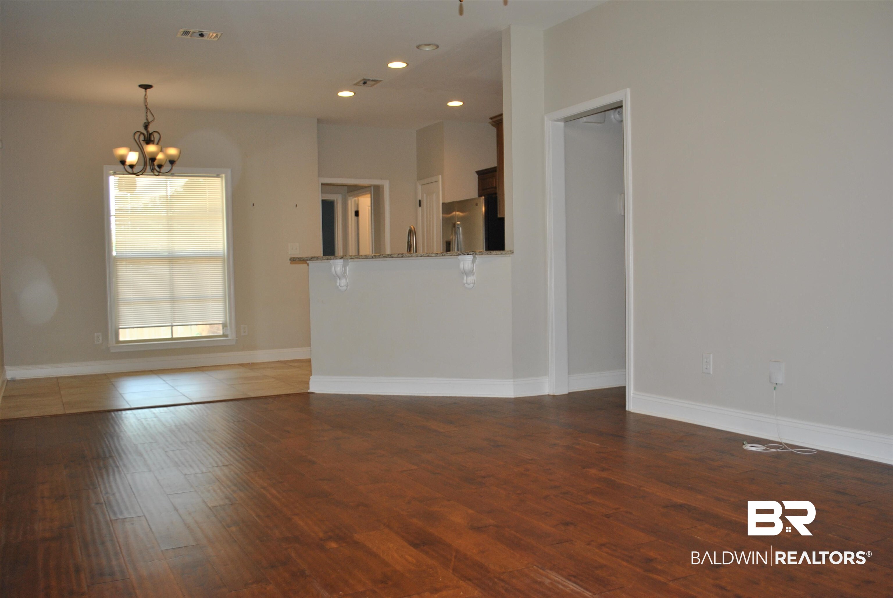 2161 Spring Grove West Mobile, AL 36695 - Photo 8 of 31 Unfurnished living room featuring hardwood / wood-style floors, a chandelier, and recessed lighting