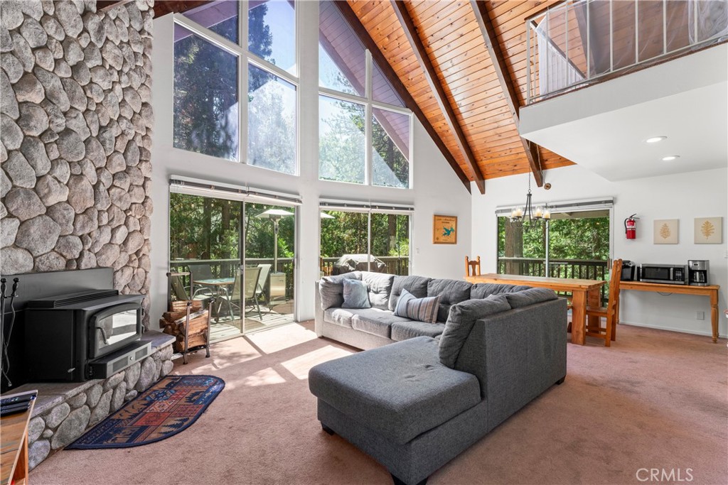 676 Rhine Road Lake Arrowhead, CA 92352 - Photo 4 of 20 a living room with furniture a fireplace and a floor to ceiling window