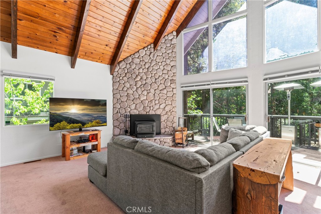 676 Rhine Road Lake Arrowhead, CA 92352 - Photo 5 of 20 a living room with furniture a fireplace and a floor to ceiling window