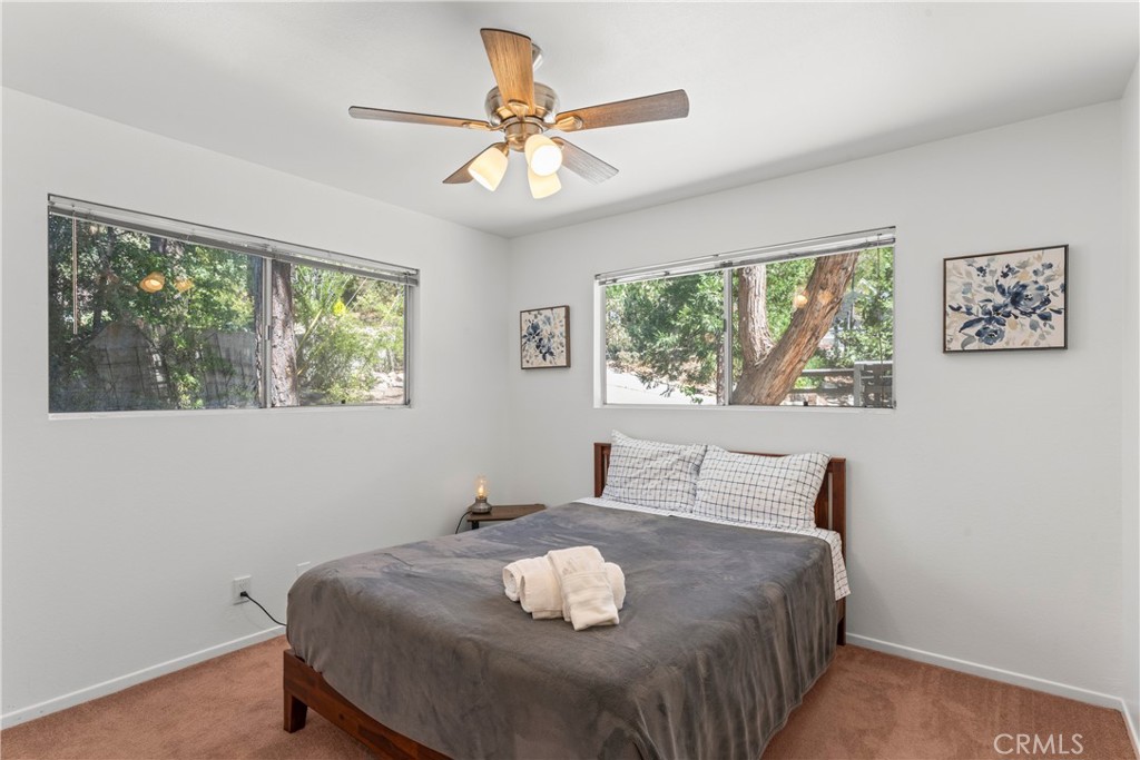 676 Rhine Road Lake Arrowhead, CA 92352 - Photo 10 of 20 a bedroom with a bed and a window