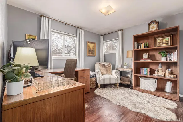 a living room with furniture window and wooden floor